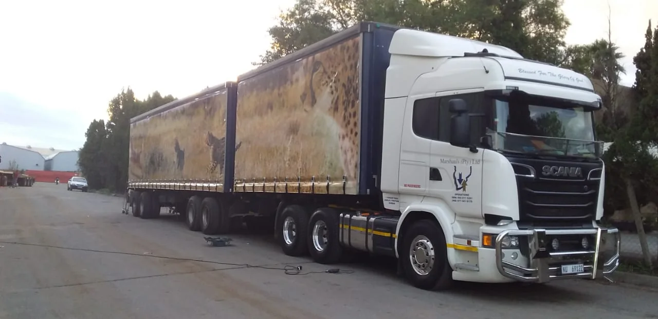 Scania interlink in cheetah livery at an industrial depot at dusk